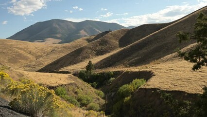 Sticker - Big  hills and mountains with green trees against the blue sunny sky