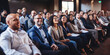 © Jasmina - Group of smiling businesspeople listening to a presentation.