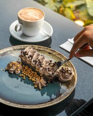 Wall Mural - Vertical shot of a chocolate brownie and a latte