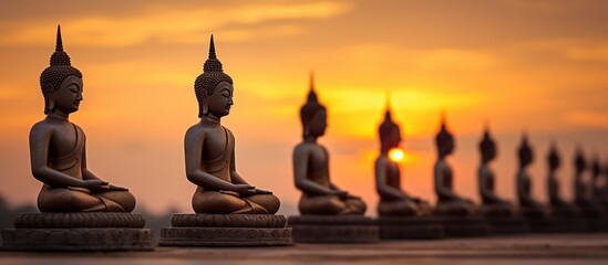 Multiple Buddha statues at sunset in southern Thailand