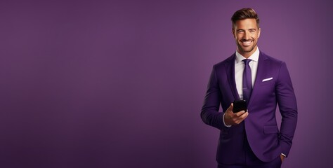 portrait of professional businessman in business suit with hand in pocket holding mobile phone and looking at camera on purple background, advertising promotion banner, copy space