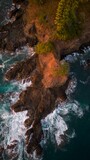 Fototapeta Morze - Aerial view of ocean waves splashing on rocks