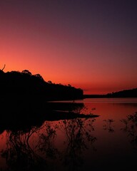 Sticker - Vertical of red sunset over a tranquil lake in Brockham, England