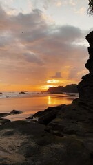 Poster - Vertical shot of a bright sunset sky over a tropical beach in Bali, Indonesia