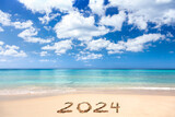 Fototapeta Boho - 2024 written on sandy beach
