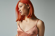 © LIGHTFIELD STUDIOS - portrait of sensual young asian woman with red hair posing in slip dress on grey backdrop, feminine