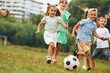 © standret - Playing soccer. Kids are having fun on the field at daytime together