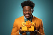handsome adult black man with glasses holds gift box in his hands