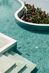 Vertical of tropical swimming pool in the jungle surroundings in Bali