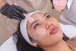 © Mdv Edwards - Using a cosmetic spatula to spread RF cream to a patients forehead prior to a Radiofrequency skin tightening treatment. At a facial care, dermatologist or aesthetic clinic.