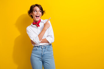 Canvas Print - Photo of surprised young girl stylist indicate finger empty space interesting design brand luxury store isolated on yellow color background