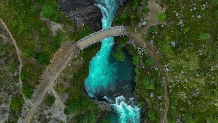 Wall Mural - Drone footage over bridge and Hvita river near the Hraunfossar waterfalls in Iceland