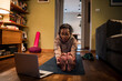 © Marko Geber - Senior African American woman mimicking a workout video on her laptop at home