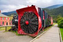 Retired Rotary Snow Plow At The Front Of An Old White Pass & Yukon Railroad Train In The City Center Of Skagway, Alaska - Old Snow Blower Train In The Klondike Gold Rush National Historic Park