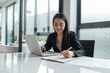 © Charlie's - Beautiful confident asian business woman working with laptop Hands typing  keyboard. Professional investor working new start up project. business planning in office. Technology business