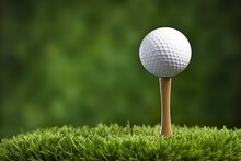 White Golf Ball On Wooden Tee With Grass.