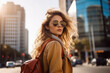 © ty - portrait of stylish young woman walking on a sunny day, wearing backpack in the city with skyscrapers