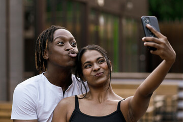 couple of african black persons making a selfie on a travel vacation, romance love tour