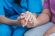 Close up images, The doctor holding hands patient  to give advice and encourage To fight the disease And cheer to receive treatment, to elderly patient and health care concept.