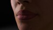 Woman's face close-up on a black background. Nose and lips. Human skin. A shadow falls on the face. 3d illustration