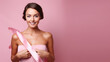 © Cedric - portrait of a woman with pink ribbon in front of pink background. empty space for text