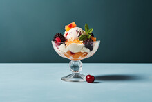 Ice Cream In A Glass Bowl In A Minimal Background. Food Photography, Vanilla Ice Cream Cup With Cherries, Berries And Fruits In An Elegant Glass Cup Isolated On A Minimal Background, Delicious Sundae