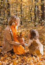 Young Mother With Her Little Daughter In An Autumn Park. Fall Season, Parenting And Children Concept.