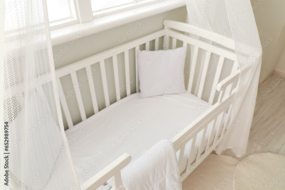 Interior of stylish children's bedroom with crib