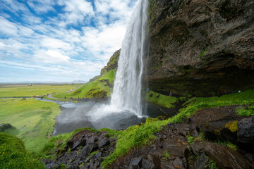 Wall Mural - Seljalandsfoss waterfall in Iceland, approaching the back side of the falls