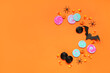 © Pixel-Shot - Halloween composition with bat, spiders and candies on orange background