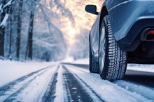 Car Tires In Winter On Slippery Road Covered With Snow. Danger On Winter Trip.