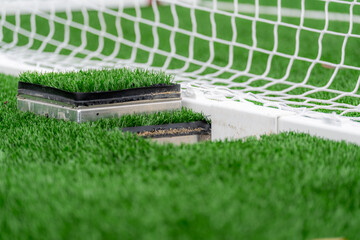 Wall Mural - Photo of synthetic turf field clamping system on a soccer goal.	