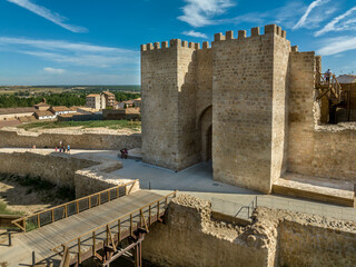 Canvas Print - Aerial view of Almazan city walls, fortified gate, battlements above the Ebro river in Spain with cloudy blue sky