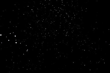 Snow on a black background. Snowflakes in the form of stars. Snowfall.