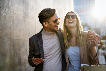 Wall Mural - happy smiling couple having fun together in city. people travel business happiness concept