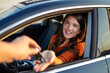 © Graphicroyalty - Salesman handling car keys to woman. businesswoman receiving keys of her new status car from dealer