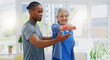 Elderly woman, dumbbells and rehabilitation therapist for exercise in a nursing home. Happy senior patient with physiotherapist man or nurse for healing, health and physiotherapy for muscle and body