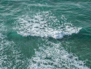 Wall Mural - ocean foamy pattern on water surface. top view.