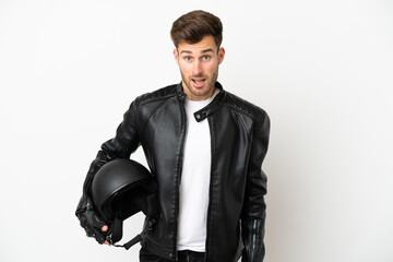 Young caucasian man with a motorcycle helmet isolated on white background with surprise facial expression