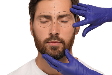 Poster - Doctor checking patient's face before cosmetic surgery operation on white background, closeup