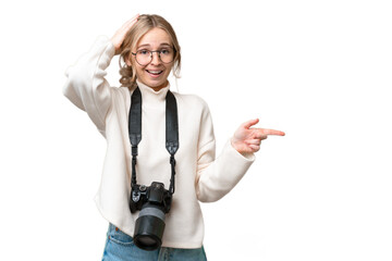 Sticker - Young photographer English woman over isolated background surprised and pointing finger to the side