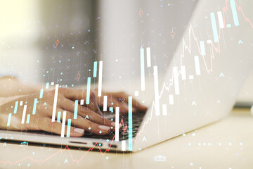 Poster - Abstract creative financial graph with hand typing on laptop on background, forex and investment concept. Multiexposure