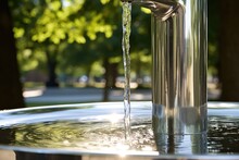 Close-up Of A Stainless Steel Drinking Fountain In A Public Park