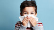 Closeup of a child with a tissue for a runny nose.