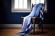 blue tallit prayer shawl draped over a chair