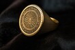 close-up of a gold signet ring on a black cloth