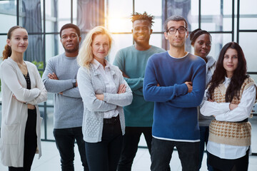 Wall Mural - Group of business people standing at the window of a modern office