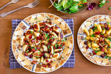 A traditional Polish cuisine dish: potato dumplings with bacon and onion