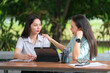 © EduLife Photos - A young Asian college student meets her teacher advisor or a tutor to discuss the academic project