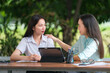 © EduLife Photos - A young Asian college student meets her teacher advisor or a tutor to discuss the academic project